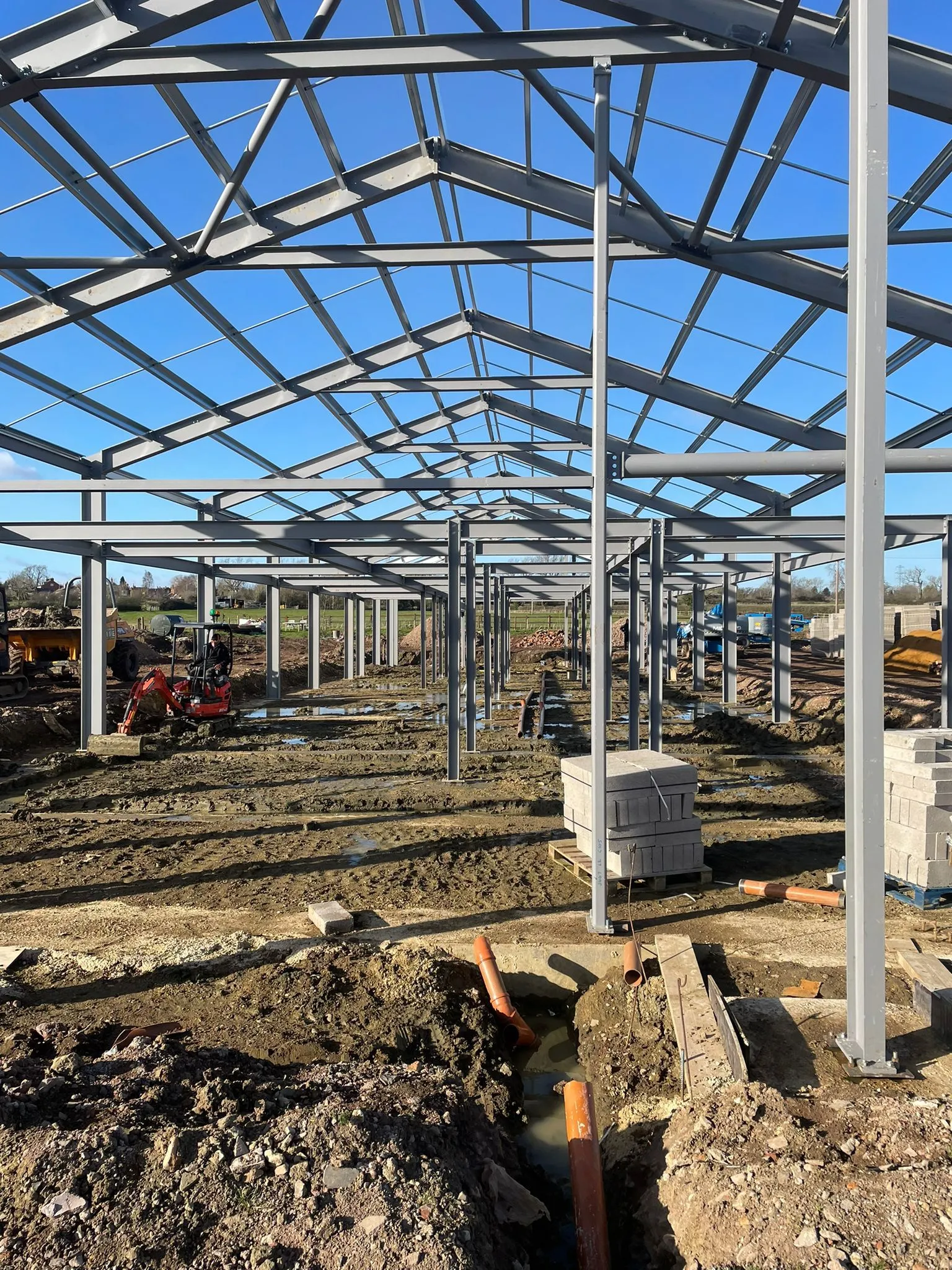 a building under construction with a lot of dirt